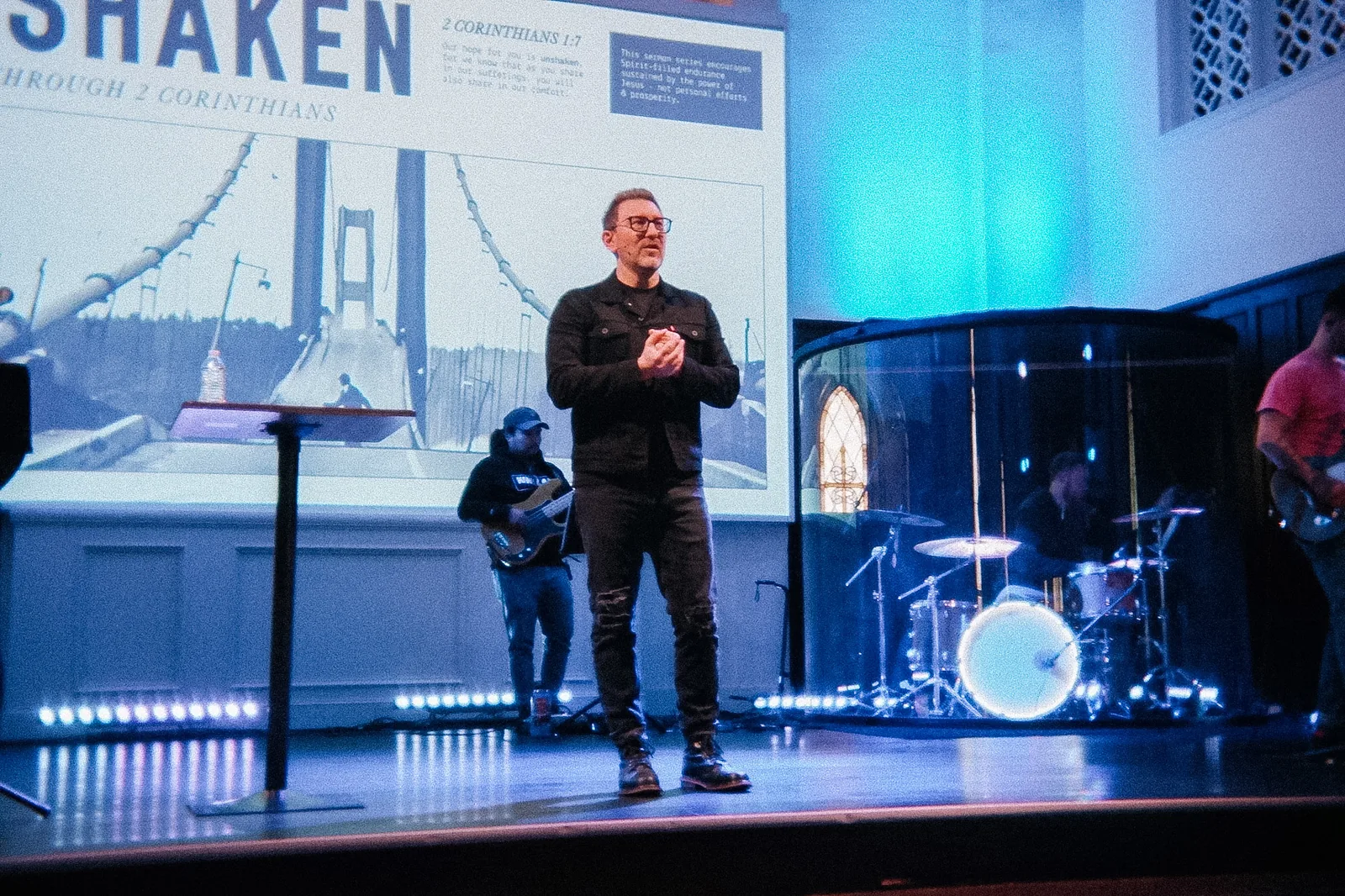 Bubba Jennings on stage at Resurrection Church, the title of his sermon series on the screen behind him