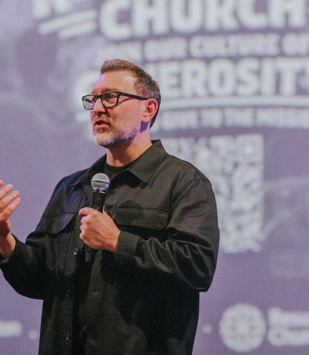 Bubba Jennings, lead pastor of Resurrection Church, preaching with a microphone